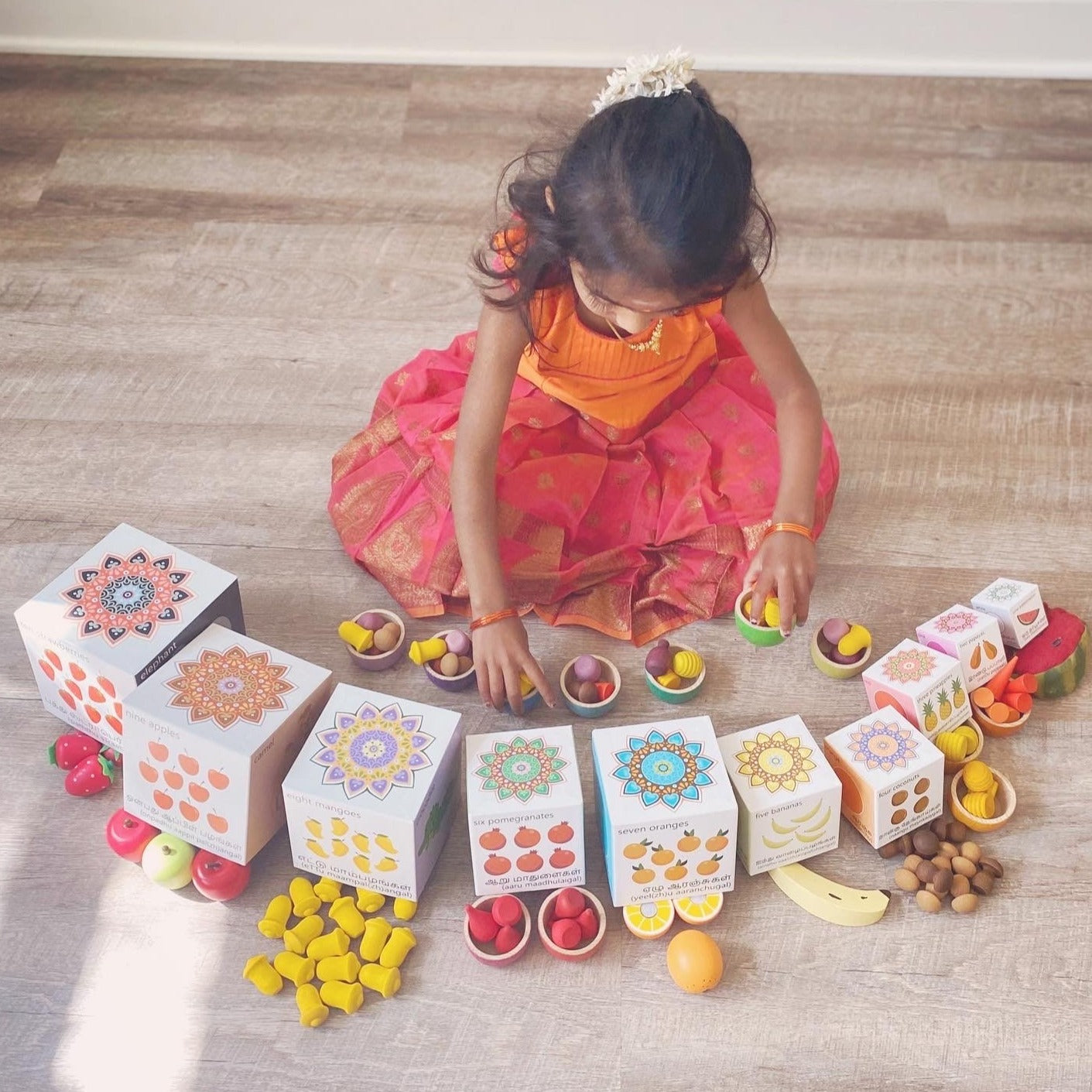 Indian girl playing with Tamil blocks. Learn colours, numbers, animals, fruits and counting. Stack them up or nest them.